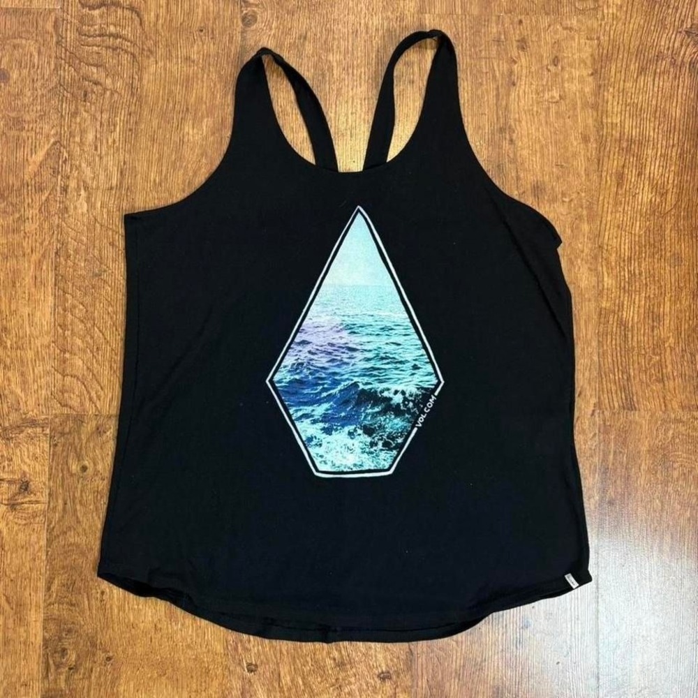 Woman's Volcom black tank top with blue wave graphic. Item 521